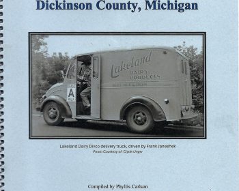 The cover of a spiral-bound book titled “Dairies That Delivered Milk to the Residents of Dickinson County, Michigan” with a black-and-white photo of a vintage Lakeland Dairy delivery truck and driver.