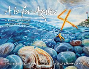 Book cover titled "A Is for Agates: A Lake Superior Alphabet Book" shows illustrated blue water, agate stones, a bird's legs, and a lighthouse in the background. Text credits Patti Barash and Lisa Perrin-Kosmo.