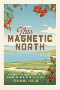 Book cover for "This Magnetic North" by Tim Mulherin, showing illustrated cherry branches in the foreground, a landscape with water, green hills, and a blue sky with clouds in the background.