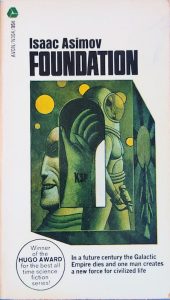 Cover of the book Foundation by Isaac Asimov, featuring an illustration of an astronaut and a face, with a sticker stating it won the Hugo Award.
