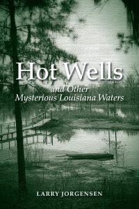 Book cover for Hot Wells and Other Mysterious Louisiana Waters by Larry Jorgensen, featuring a monochrome landscape of a wooden pier and a small boat on a misty body of water.